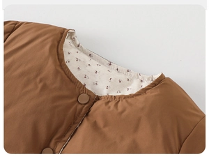 Close-up of caramel quilted puffer jacket with floral lining and snap buttons