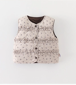 Detail of floral down vest showing ruffled layers and wood buttons on cotton fabric