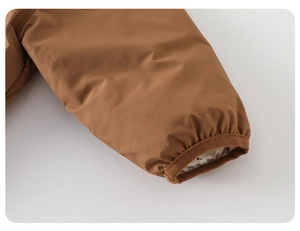 Detail of elastic cuff on brown down jacket with floral lining and windproof fabric