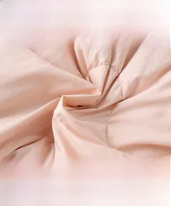 Macro detail of soft light pink quilted fabric texture for baby winter thermal clothing