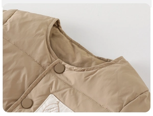 Detail shot of khaki quilted baby vest featuring round neck and white leaf embroidery