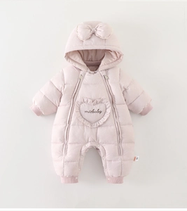 Detail of pink polka dot baby romper featuring double zippers and heart-shaped embroidery