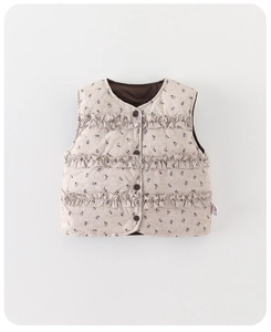 Detail view of floral toddler down vest with wooden buttons and layered ruffle accents