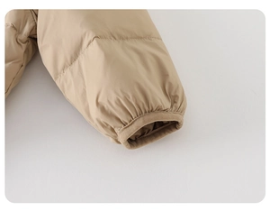 Detailed close-up of elastic cuffs and fine stitching on a beige down jacket