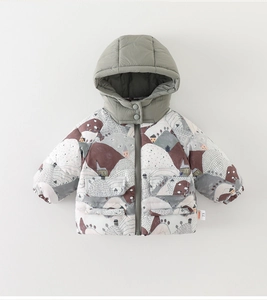 Detail of infant winter hooded jacket with sage green fabric and artistic house prints