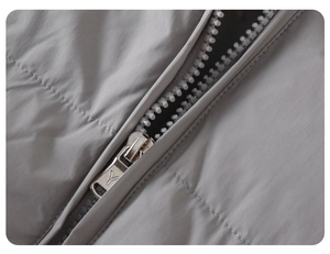 Detailed close-up of high-quality resin zipper and metal slider on baby down jacket
