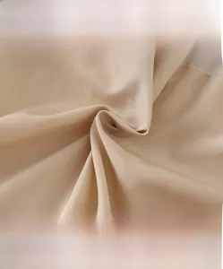 Macro detail of breathable champagne satin fabric with soft silk texture and high-density weave
