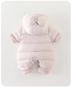 Detail of baby winter romper in pink with polka dots and lace bow on the hood