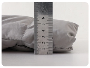 Close-up of baby puffer jacket showing 4cm thickness with a ruler for quality check