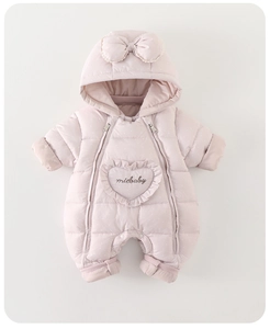Detail of pink polka dot baby romper featuring a heart embroidery and cute bow hood
