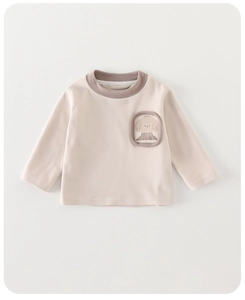 Detailed view of baby cotton sweatshirt featuring a cute cartoon dog pocket design