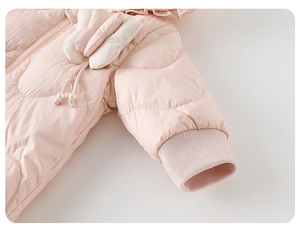 Detail of pink baby down jacket featuring 3D bow, pearl drawstring and ribbed cuffs