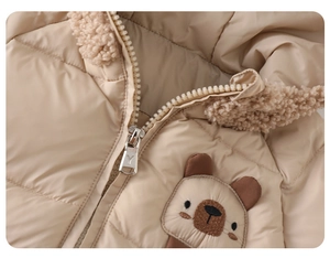 Detail of baby winter jacket with zipper, teddy fleece collar and cute bear embroidery