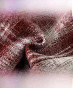 Macro shot of high-density red and white plaid wool blend fabric texture for baby coats