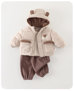Flat lay detail of winter baby boy 3-piece set with bear ear hood and dog embroidery