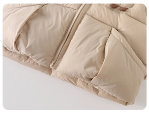 Close-up of baby boy winter padded jacket with quilted square patterns and front zipper