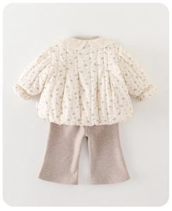 Detail of floral quilted jacket with lace collar and flared trousers for toddler girls