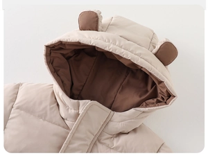 Close-up of baby winter hooded jacket with cute brown bear ears and quilted texture