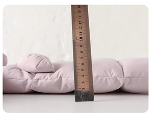 Detail showing the 50mm thickness of the quilted warm winter baby romper in light purple