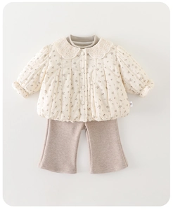 Detail view of quilted floral jacket with lace collar and flared trousers for infants
