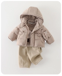 Detailed flat lay of baby boys winter 3-piece set with a plush bear on the hooded coat