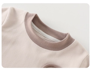 Detail of baby winter sweater neckline with ribbed trim and soft fleece texture