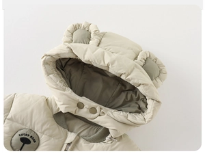 Détail de la doudoune bébé avec capuche oreilles d'ours et écusson Lucky Bear brodé