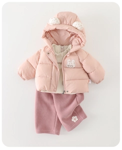 Close-up of pink winter coat with rabbit ears and floral details for baby girls