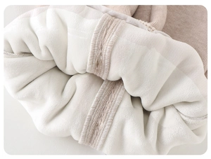 Close-up of baby winter suit showing thick white fleece lining and brown knit texture