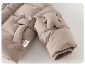 Detail of baby winter padded jacket with 3D bear doll and ribbed cuffs in khaki