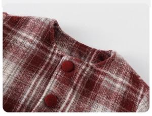 Close-up of red and white checkered wool coat neckline with vintage decorative buttons