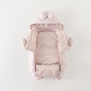 Pink hooded baby romper with white polka dots and a large bow decoration for winter