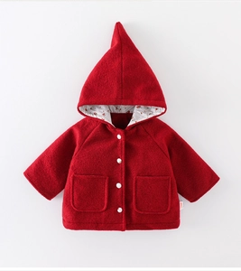 Detail of red hooded baby jacket with cherry print lining and white buttons