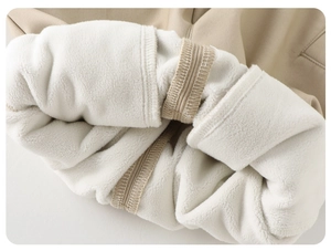 Detail view of thick khaki twill fabric with warm white fleece lining and neat stitching