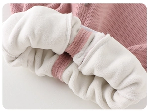 Detail of pink ribbed knit fabric with thick white fleece lining for infant winter warmth