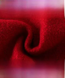 Close-up of thick red quilted wool fabric with soft texture and breathable fibers