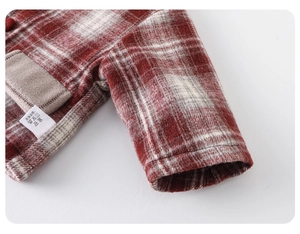 Detail of red-brown checkered wool coat showing thick warm texture and pocket stitching