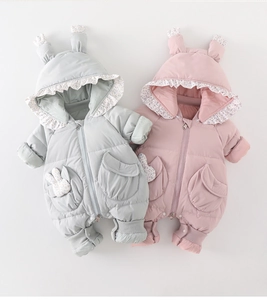 Close-up of baby winter jumpsuits featuring cute rabbit ear hoods and floral trim detailing