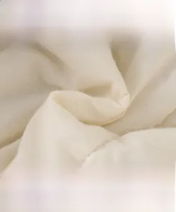 Close-up of high-density knitted white cotton fabric showing soft texture and breathability