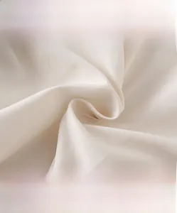 Close-up of baby white duck down jumpsuit fabric showing soft and breathable texture