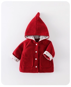 Detail of red quilted toddler coat with white buttons and floral print lining