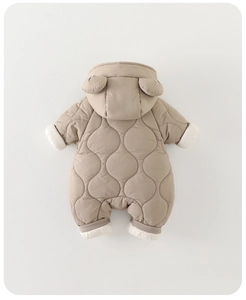 Close-up of quilted warm baby jumpsuit featuring cute hood ears and ribbed white cuffs