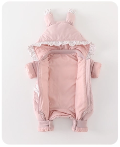 Detail of pink baby snowsuit featuring floral ruffles and convenient bottom snap buttons