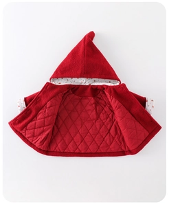Detailed view of red hooded baby jacket showing quilted lining and cherry print trim