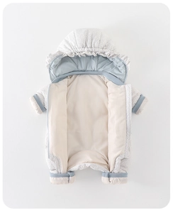 Detail of light blue polka dot baby romper with ruffled hood and thick winter padding