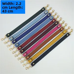 Detail showing 2.2cm wide PU leather straps in ten colors with golden metal hooks