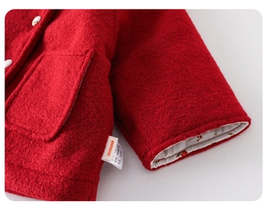Detailed shot of 100% cotton lining and red woolen texture on children's winter coat