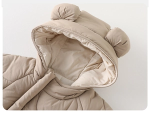 Close-up of quilted baby romper hood featuring cute 3D bear ears and soft beige fabric