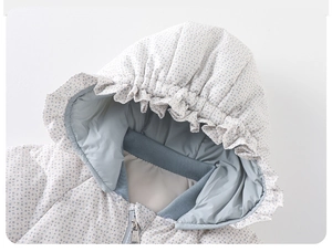 Close-up of baby floral down romper with ruffle hood edge and metal zipper detail