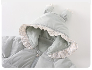 Detail of baby winter jumpsuit featuring floral lace trim hood and cute 3D decorative horns